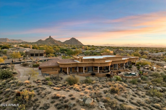 back house at dusk featuring a mountain view