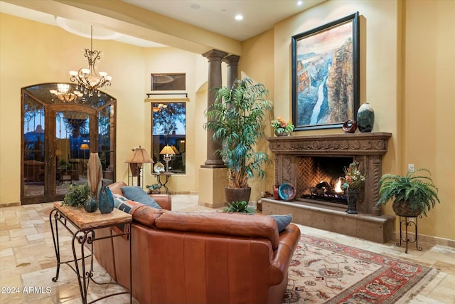 living area featuring a premium fireplace and a chandelier