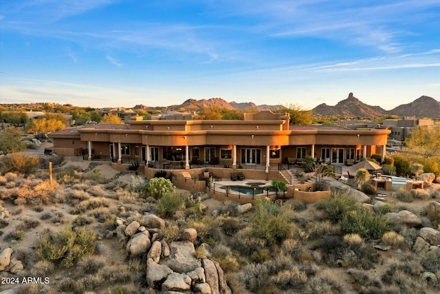 back of house with a mountain view and a patio