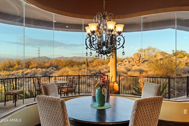 dining area featuring a mountain view and an inviting chandelier