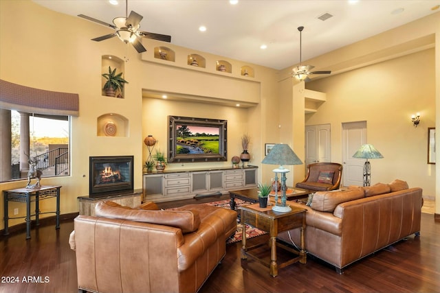 living room with ceiling fan and dark wood-type flooring