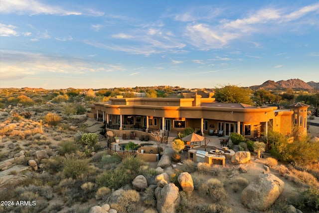 back of property with a mountain view