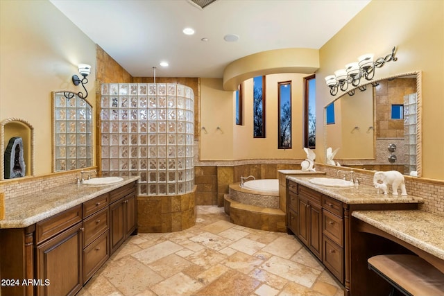 bathroom with separate shower and tub, vanity, and tile walls