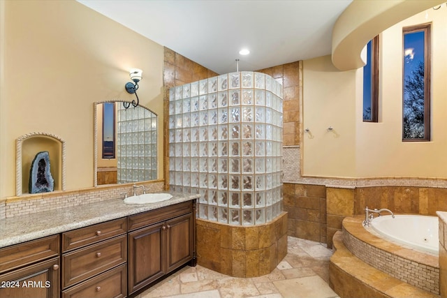 bathroom featuring a shower and vanity