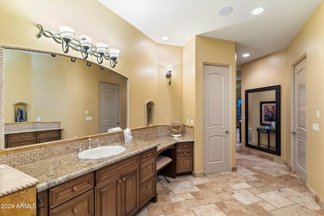 bathroom with tasteful backsplash and vanity