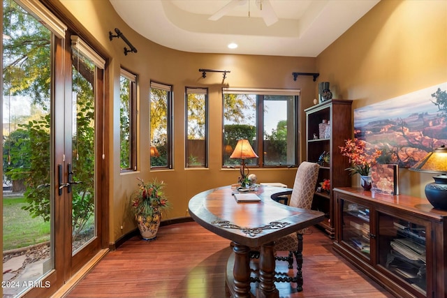 sunroom / solarium featuring ceiling fan, french doors, and a tray ceiling