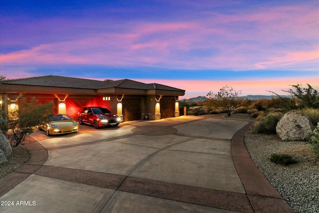 view of front facade featuring a mountain view and a garage