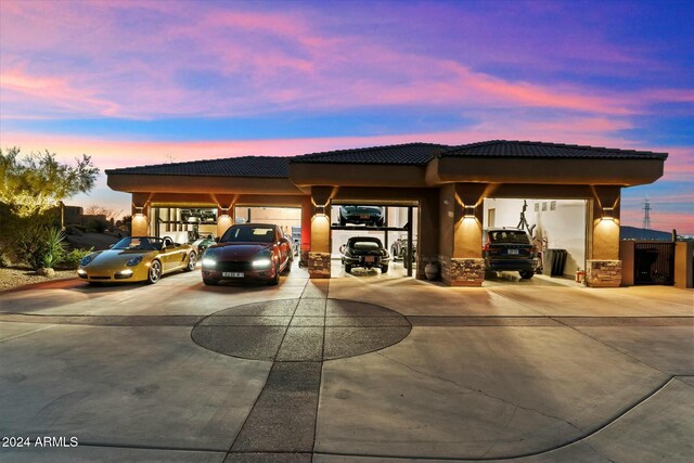 parking at dusk featuring a carport