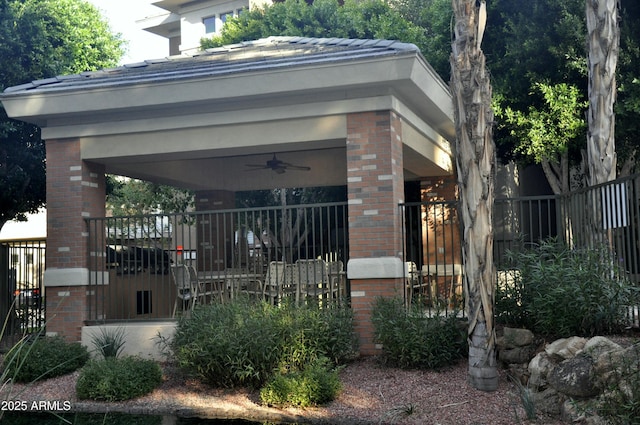 view of side of property with ceiling fan and a porch