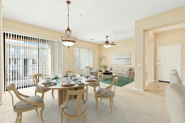 carpeted dining space featuring ceiling fan and a wealth of natural light