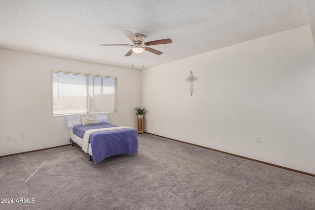 carpeted bedroom featuring a textured ceiling and ceiling fan