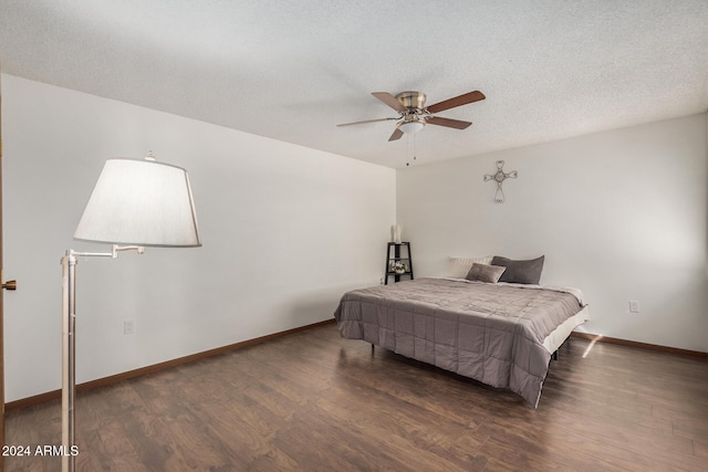 bedroom with dark wood-type flooring, a textured ceiling, and ceiling fan