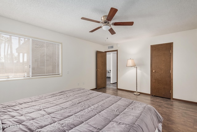 bedroom with a textured ceiling, light wood-type flooring, and ceiling fan