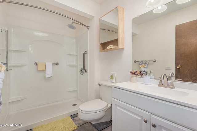 bathroom featuring vanity, toilet, and a shower