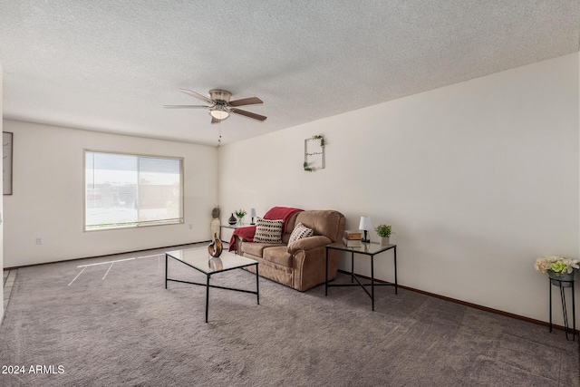 carpeted living room featuring ceiling fan and a textured ceiling