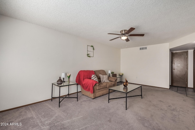 living room with light carpet, a textured ceiling, and ceiling fan