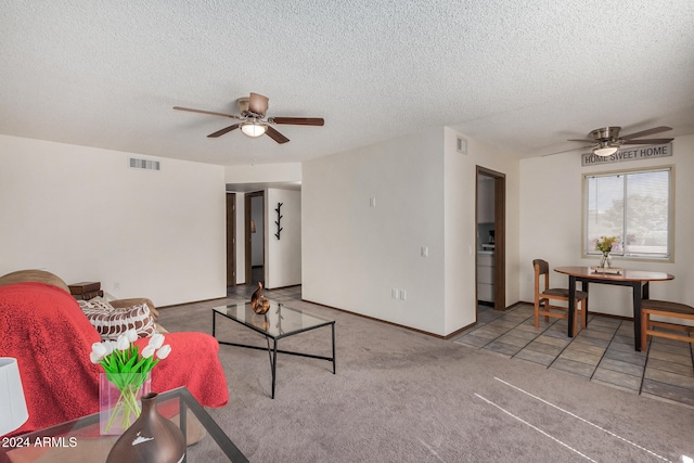 carpeted living room with a textured ceiling and ceiling fan