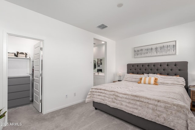 carpeted bedroom featuring ensuite bath