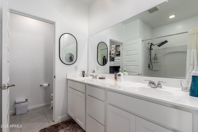 bathroom featuring walk in shower, tile patterned flooring, vanity, and toilet