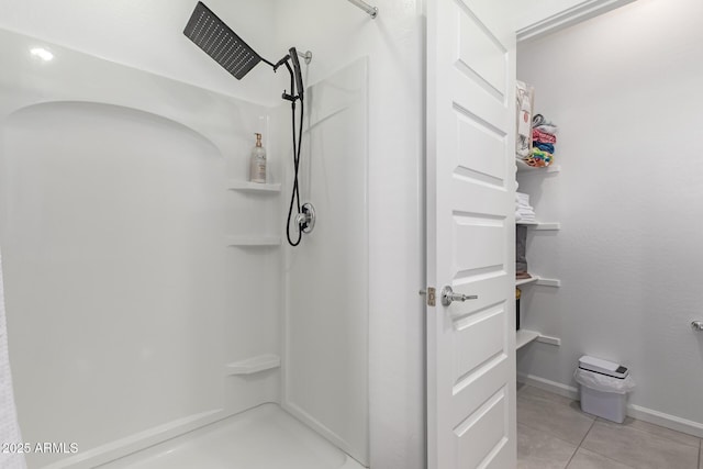 bathroom with a shower and tile patterned flooring