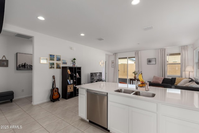 kitchen with white cabinetry, sink, light tile patterned floors, and stainless steel dishwasher