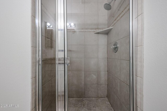 bathroom featuring a shower with door