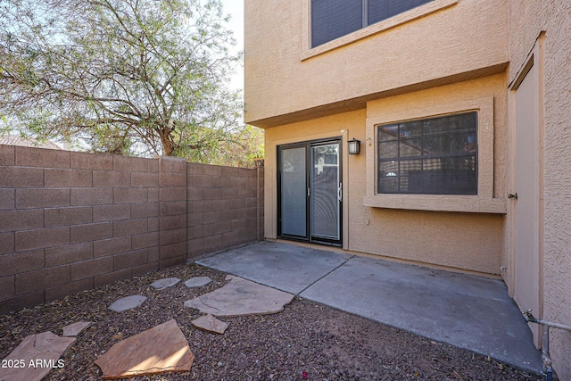 property entrance featuring a patio area