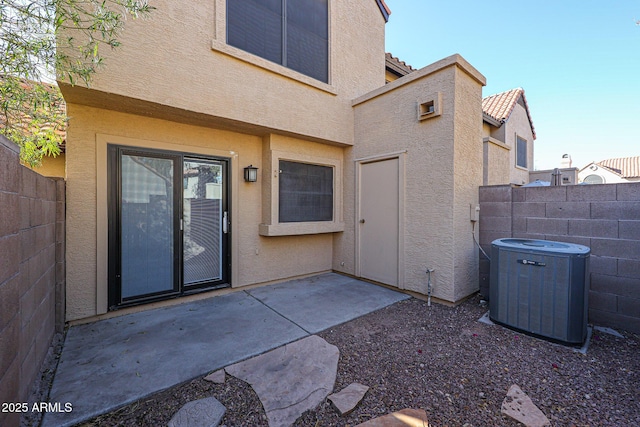 entrance to property with a patio area and central air condition unit