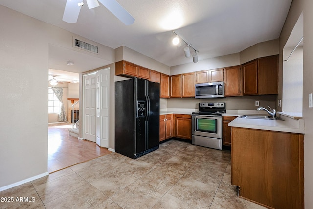 kitchen with sink, light tile patterned floors, ceiling fan, and appliances with stainless steel finishes