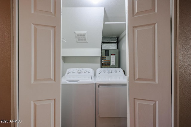 clothes washing area with washer and dryer