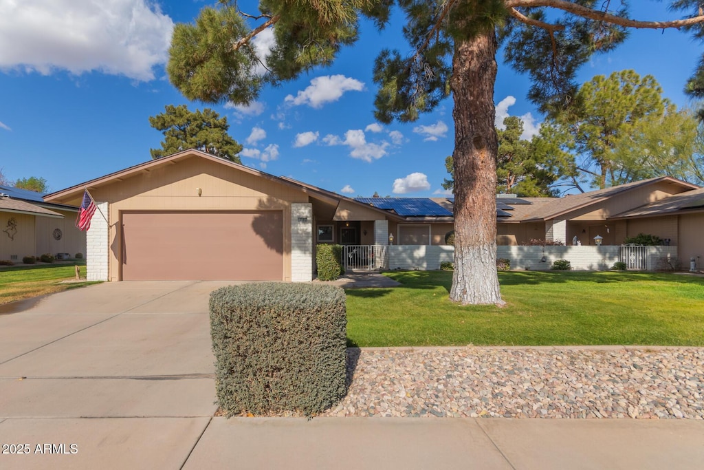 ranch-style home with a garage and a front yard