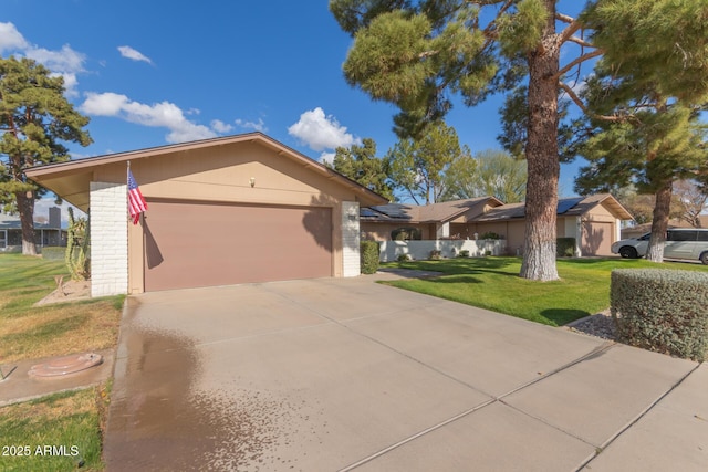 ranch-style house with a garage and a front yard