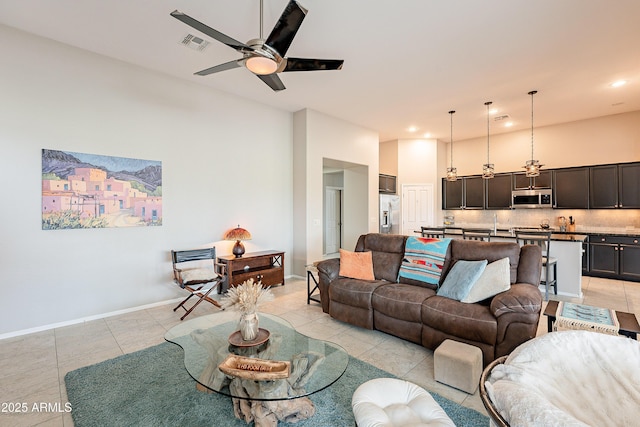 living room featuring light tile patterned floors, baseboards, visible vents, recessed lighting, and ceiling fan