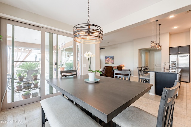 dining space featuring light tile patterned flooring, a notable chandelier, and recessed lighting