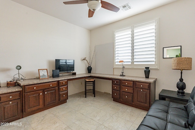 office area featuring visible vents, marble finish floor, ceiling fan, and built in study area