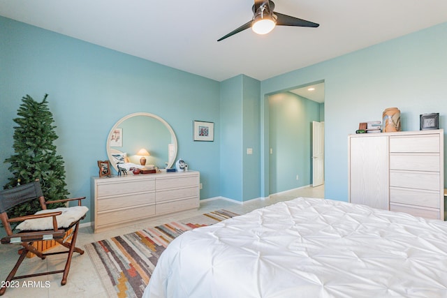 bedroom with light tile patterned floors, a ceiling fan, and baseboards