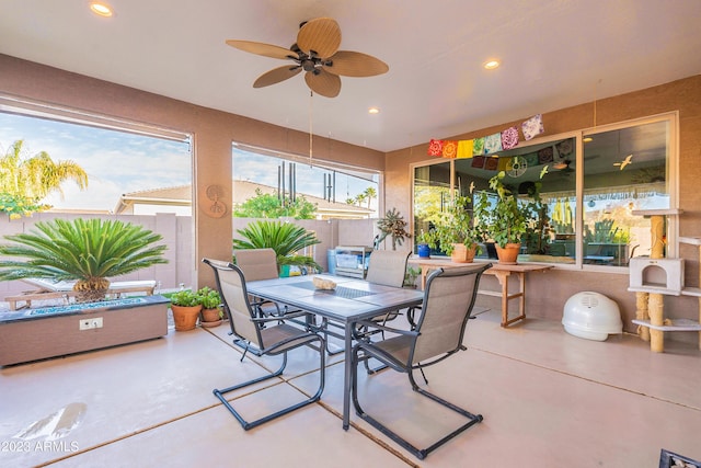 view of patio / terrace with outdoor dining space, ceiling fan, and fence