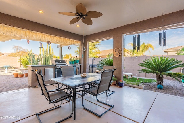 view of patio / terrace featuring outdoor dining space, area for grilling, a ceiling fan, and a fenced backyard