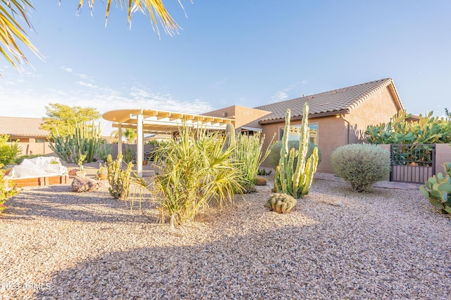 view of yard featuring a gate, fence, and a pergola