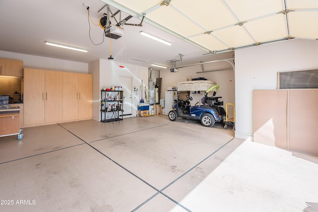 garage with gas water heater and a garage door opener