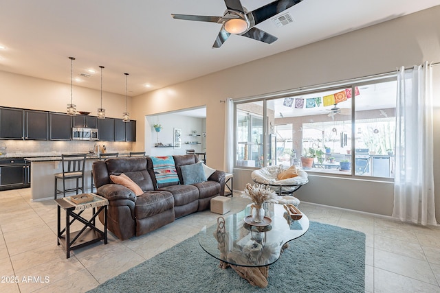 living room featuring visible vents, recessed lighting, light tile patterned floors, baseboards, and ceiling fan