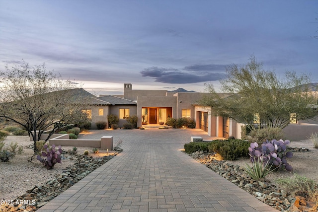 southwest-style home with decorative driveway and stucco siding