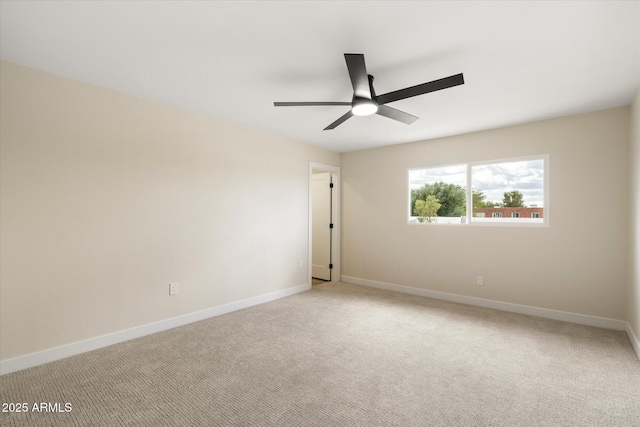 unfurnished room with light carpet, a ceiling fan, and baseboards