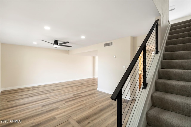 staircase with visible vents, wood finished floors, recessed lighting, baseboards, and ceiling fan