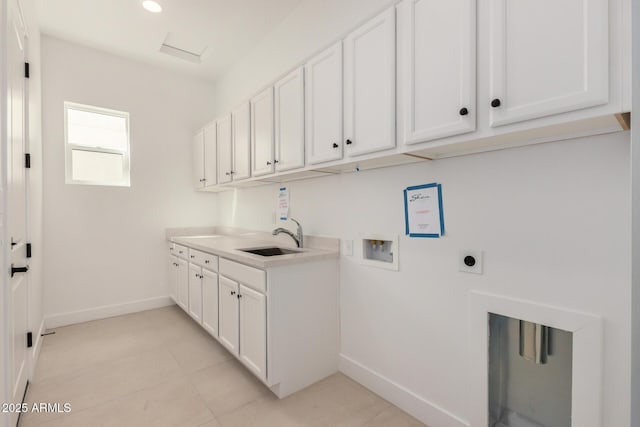 laundry area featuring washer hookup, cabinet space, hookup for an electric dryer, a sink, and baseboards