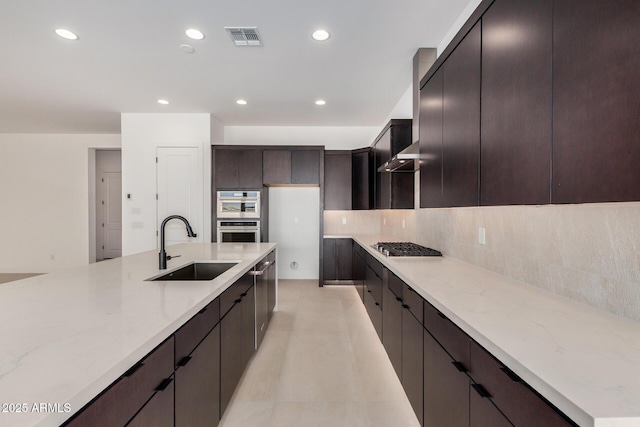 kitchen with visible vents, decorative backsplash, light stone countertops, a sink, and recessed lighting