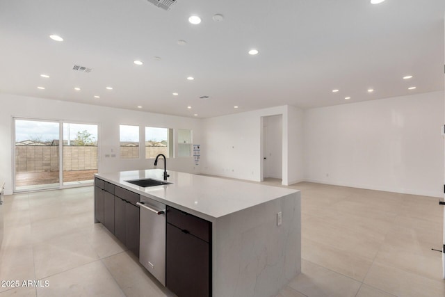 kitchen with a kitchen island with sink, recessed lighting, a sink, dishwasher, and modern cabinets