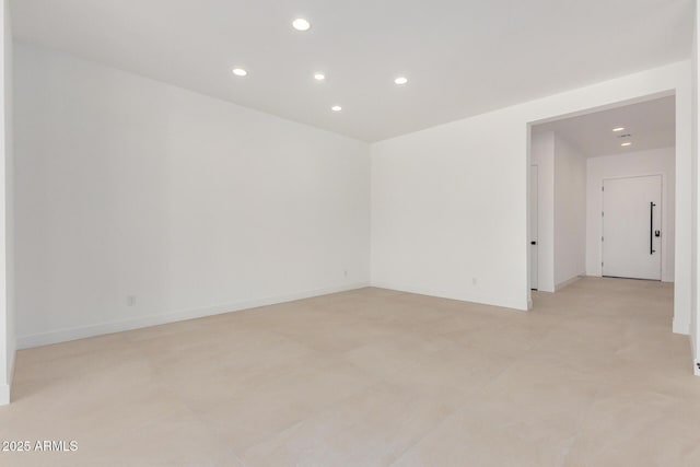 spare room with baseboards and recessed lighting