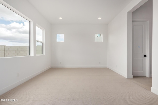 spare room featuring light carpet, baseboards, and recessed lighting