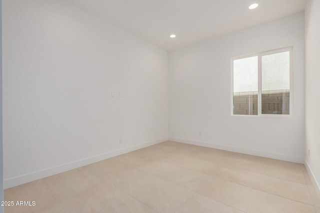 spare room featuring baseboards and recessed lighting